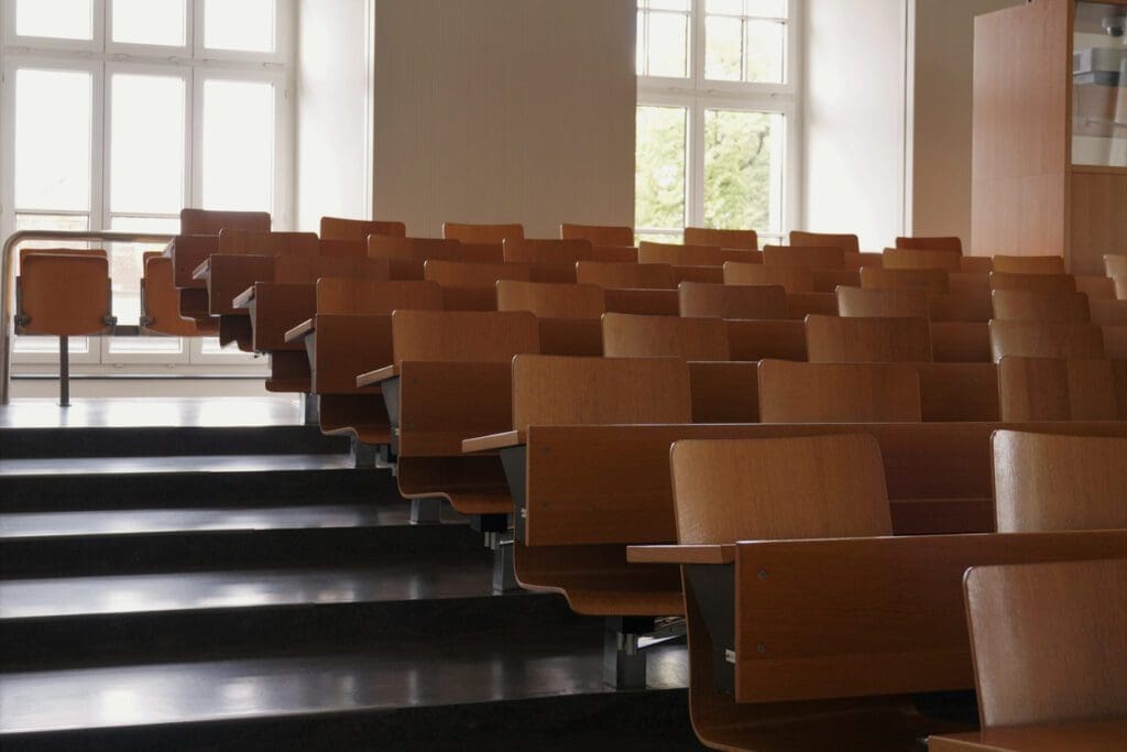 An empty university auditorium represents the impacts of high college attrition rates.