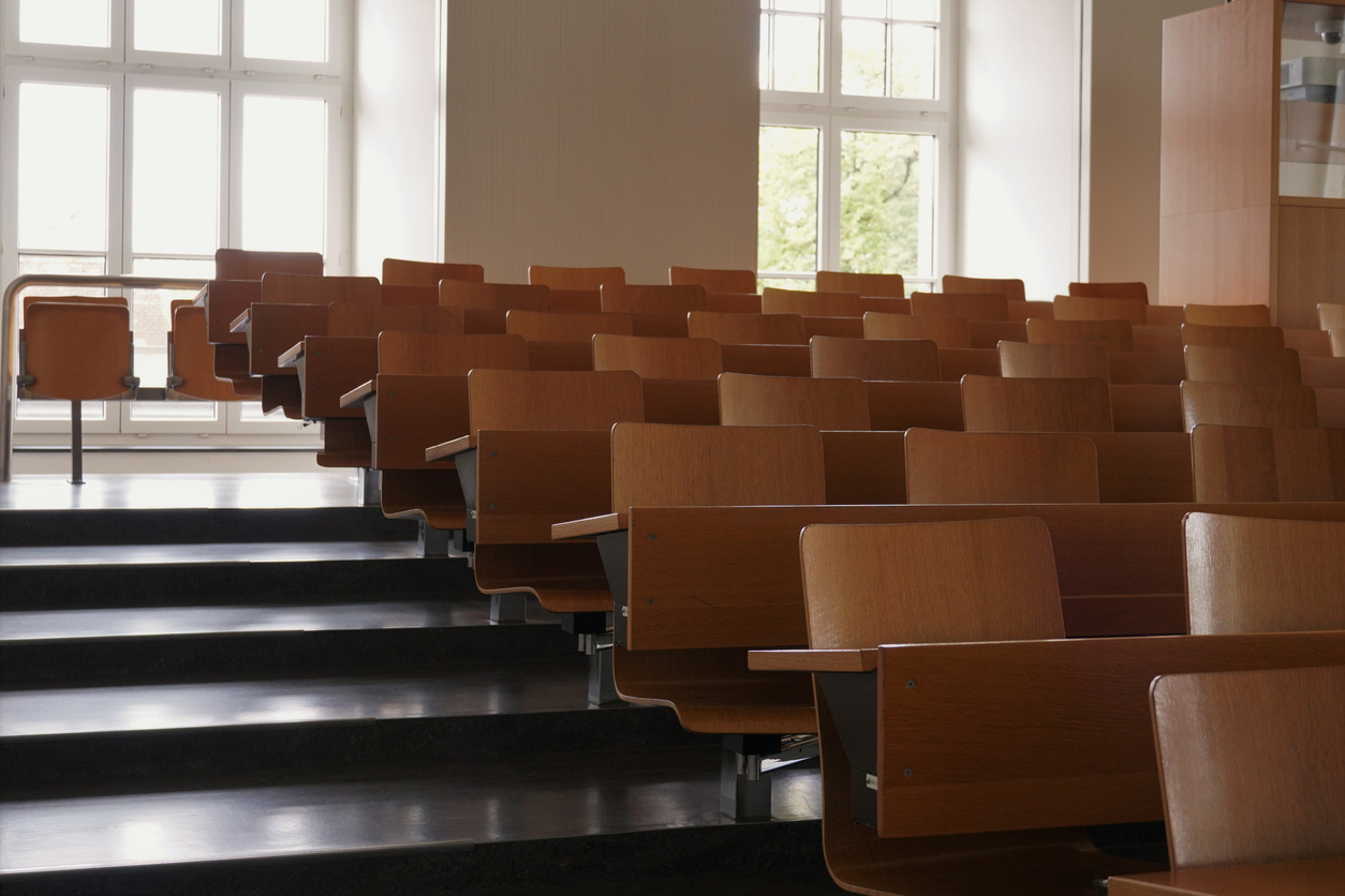 An empty university auditorium represents the impacts of high college attrition rates.