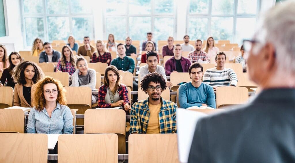 A college classroom is filled with students recruited through an effective student enrollment strategy.