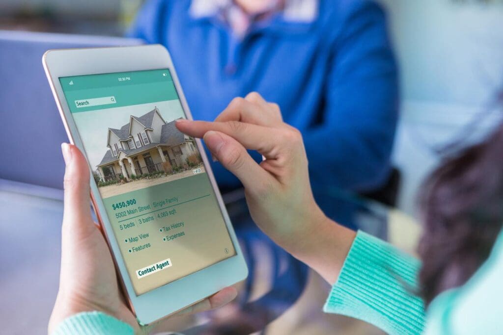 A potential homebuyer searches on her tablet for a builder, finding one through effective homebuilder SEO.