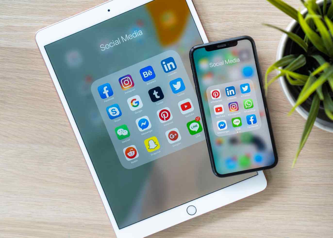 Various social media icons are shown on a tablet.
