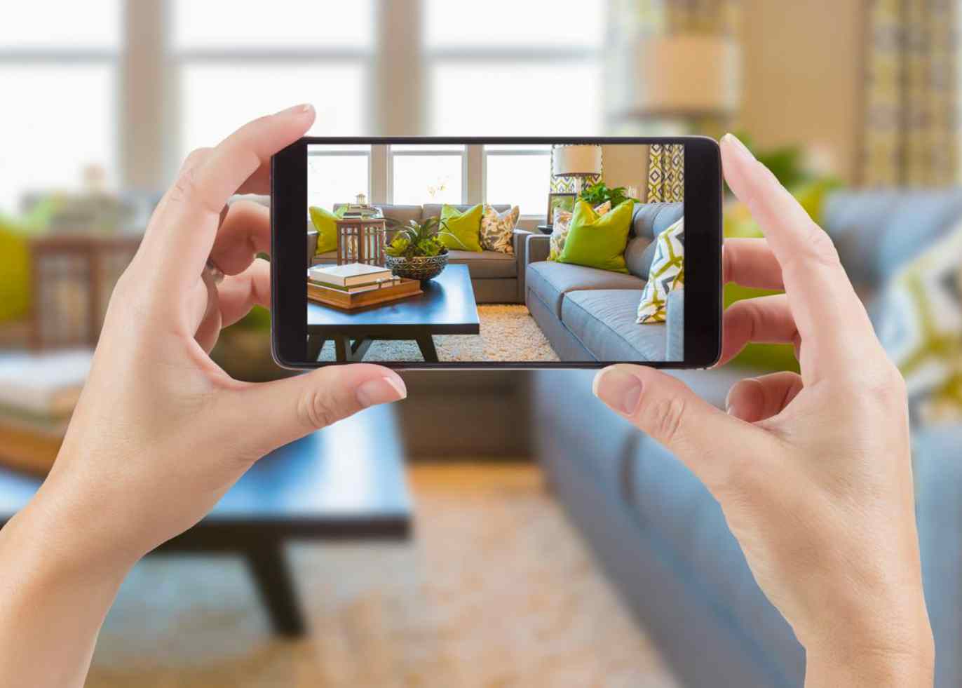 A marketer takes a video of a staged home as part of home builder advertising.