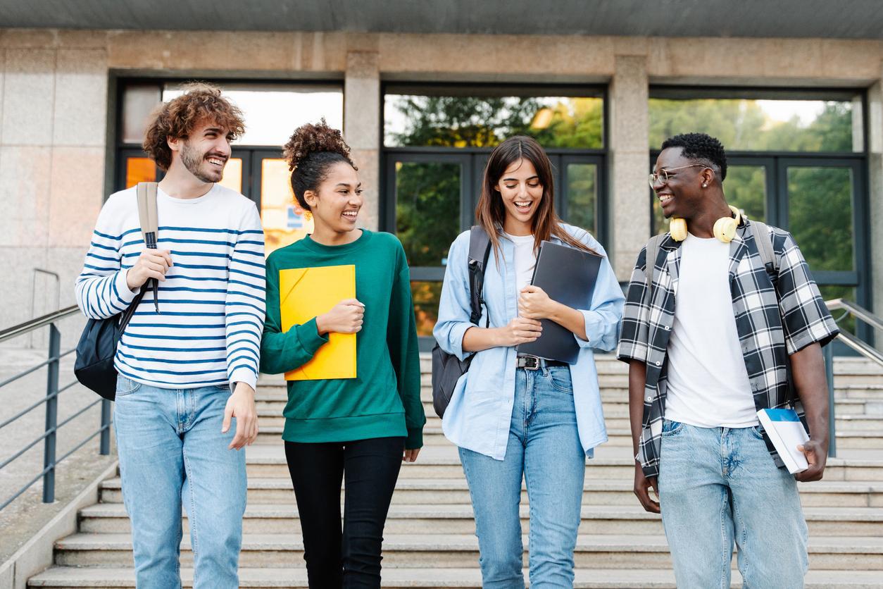 A group of college students on the steps of the school they chose as high-quality applicants.