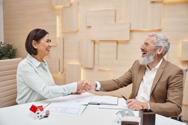 Mortgage broker and customer shaking hands