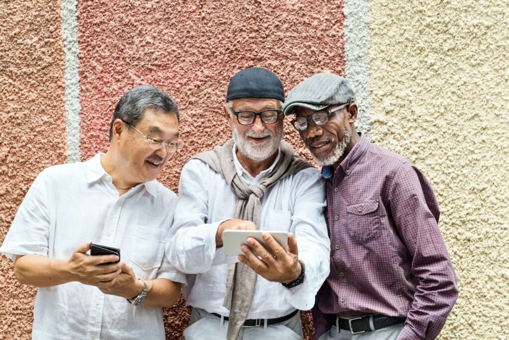 Group of seniors texting and looking at smartphone