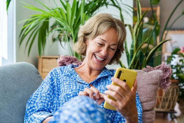 Female senior texting on smartphone