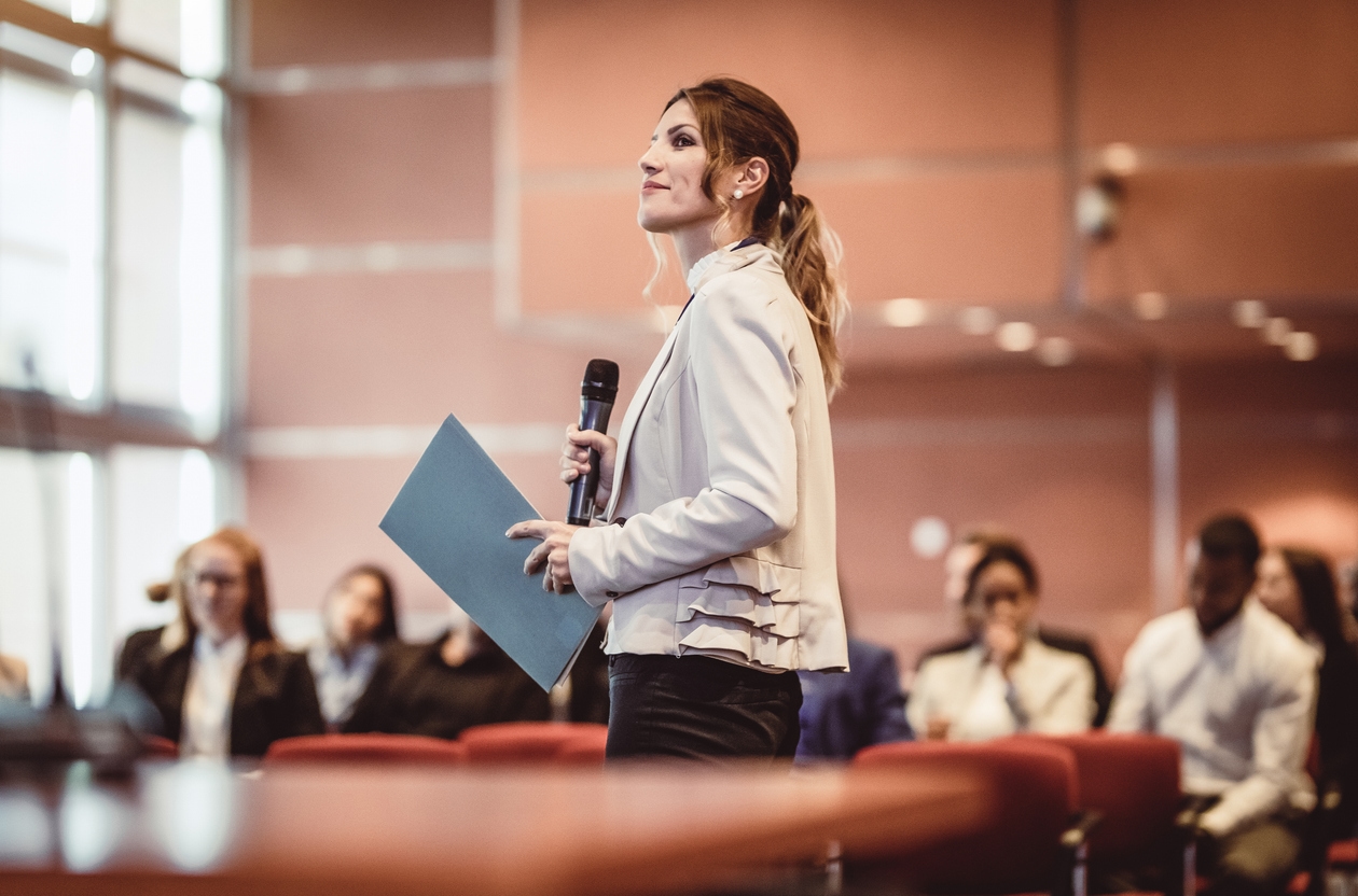 Woman presents at a higher education marketing conference.