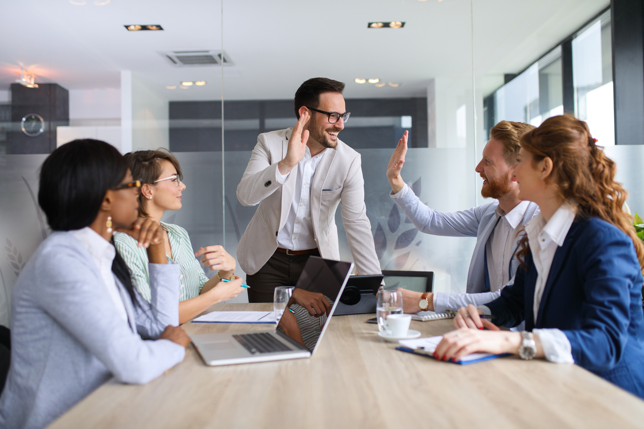 Sales and marketing teams meet to discuss efficiencies created through AI technology.