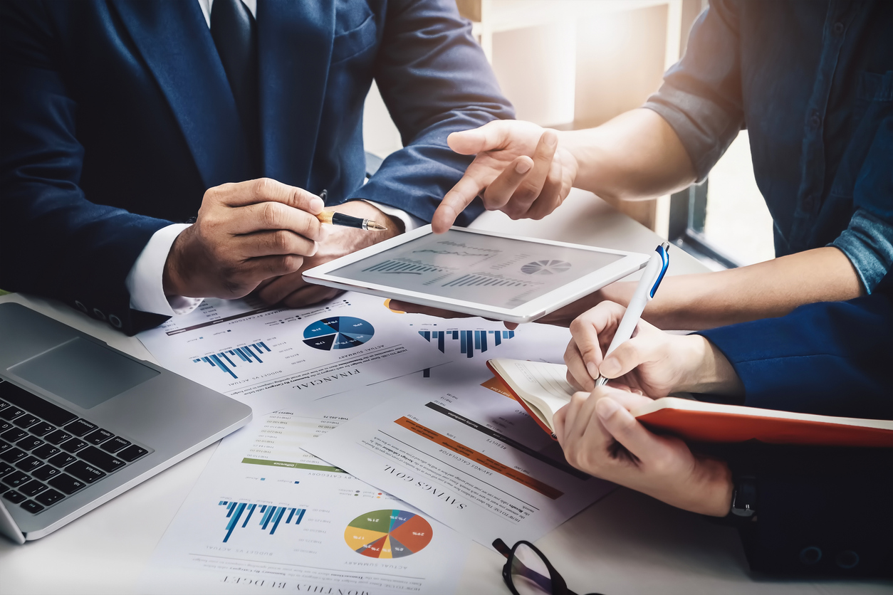 Two sales reps look at metrics generated through AI tools.
