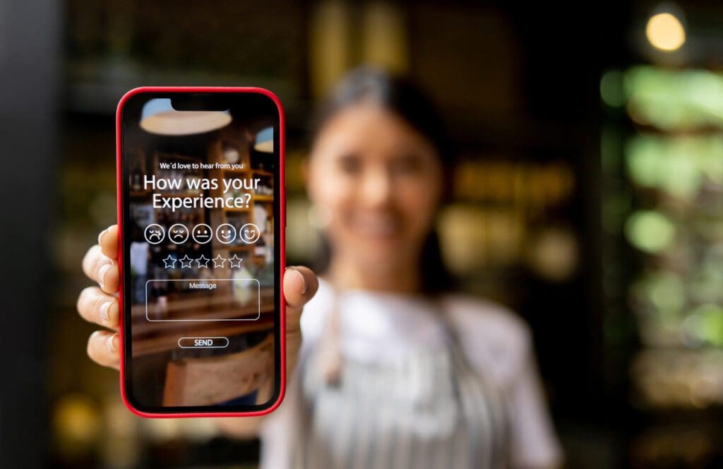 Woman holds phone that shows a customer experience rating, influenced by AI technology.