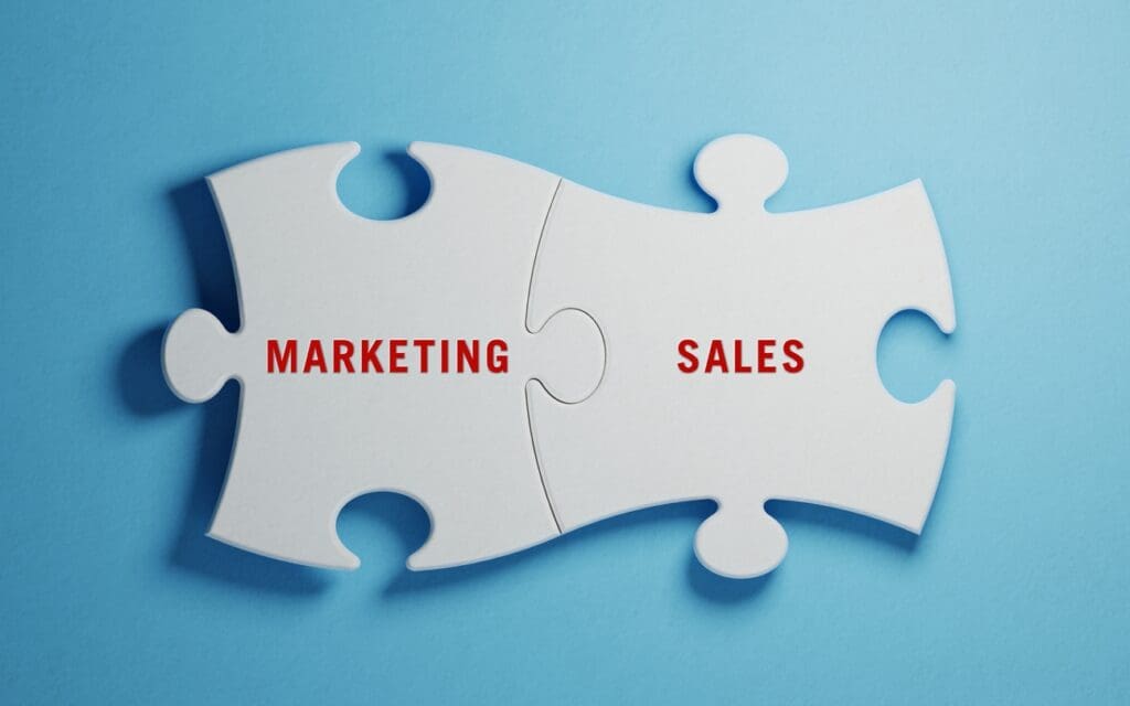 Two puzzle pieces spell marketing and sales, showing the importance of integration.