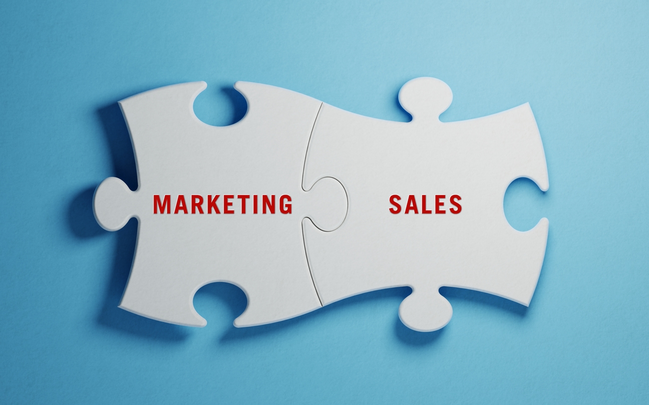 Two puzzle pieces spell marketing and sales, showing the importance of integration.