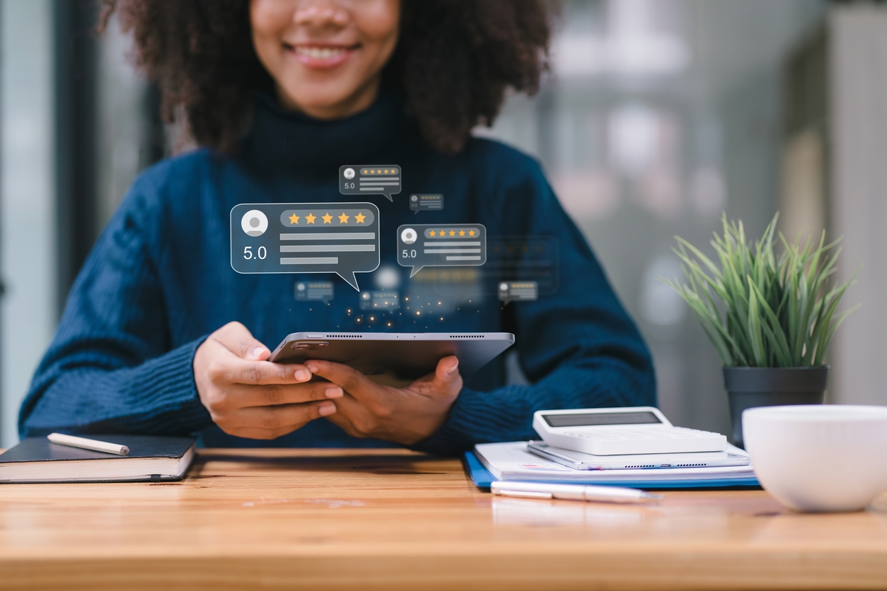 Woman leaves customer review on her tablet after being prompted by an AI digital assistant.