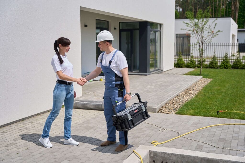 Home services technician shaking hands with a customer