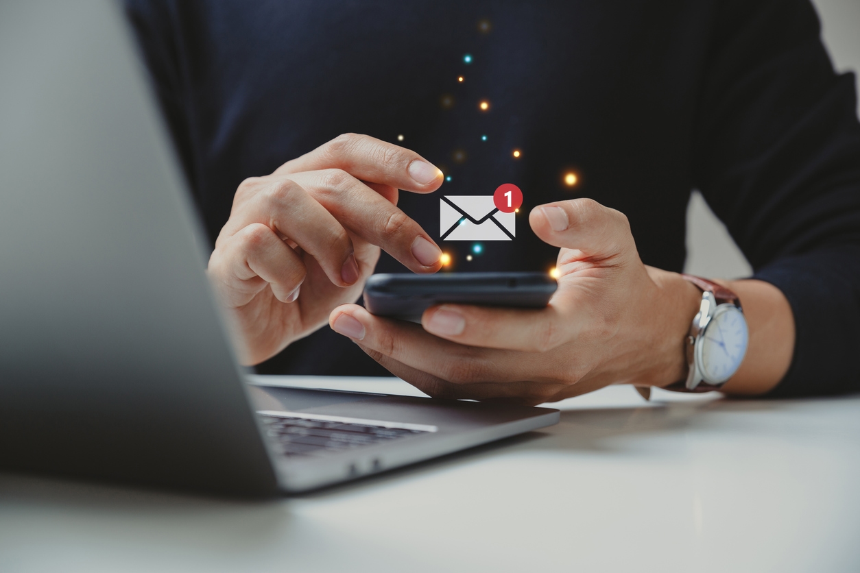 User opens a personalized email on a phone, sent via AI marketing tools.