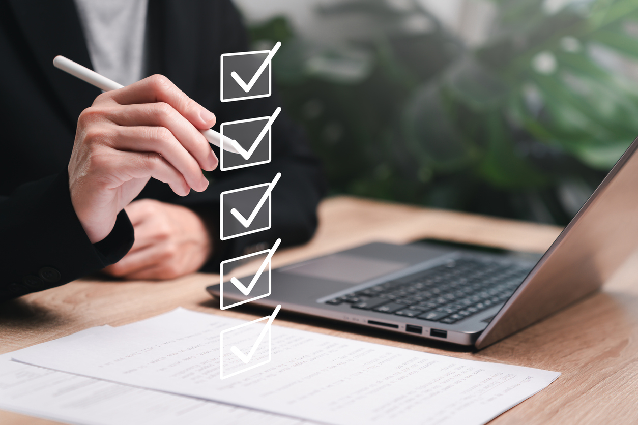 A woman checks boxes on an electronic checklist, evaluating AI digital assistants.