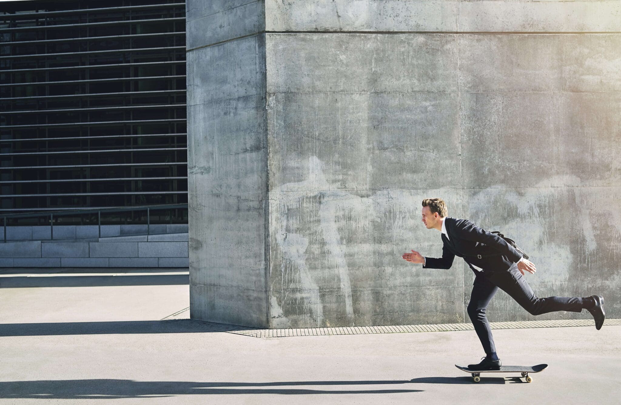 Businessman rushing forward on a skateboard