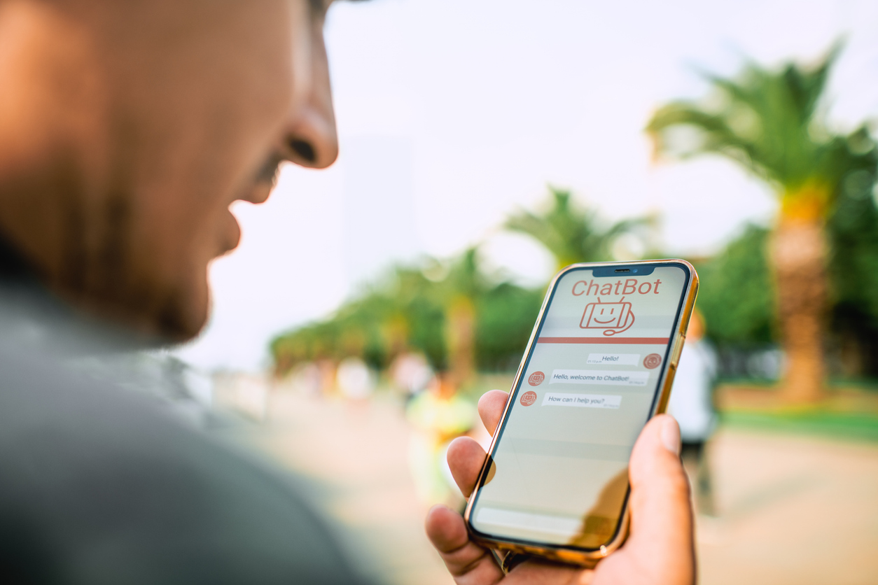 A potential homebuyer uses his phone to talk to an AI-powered chatbot to get answers to basic questions.
