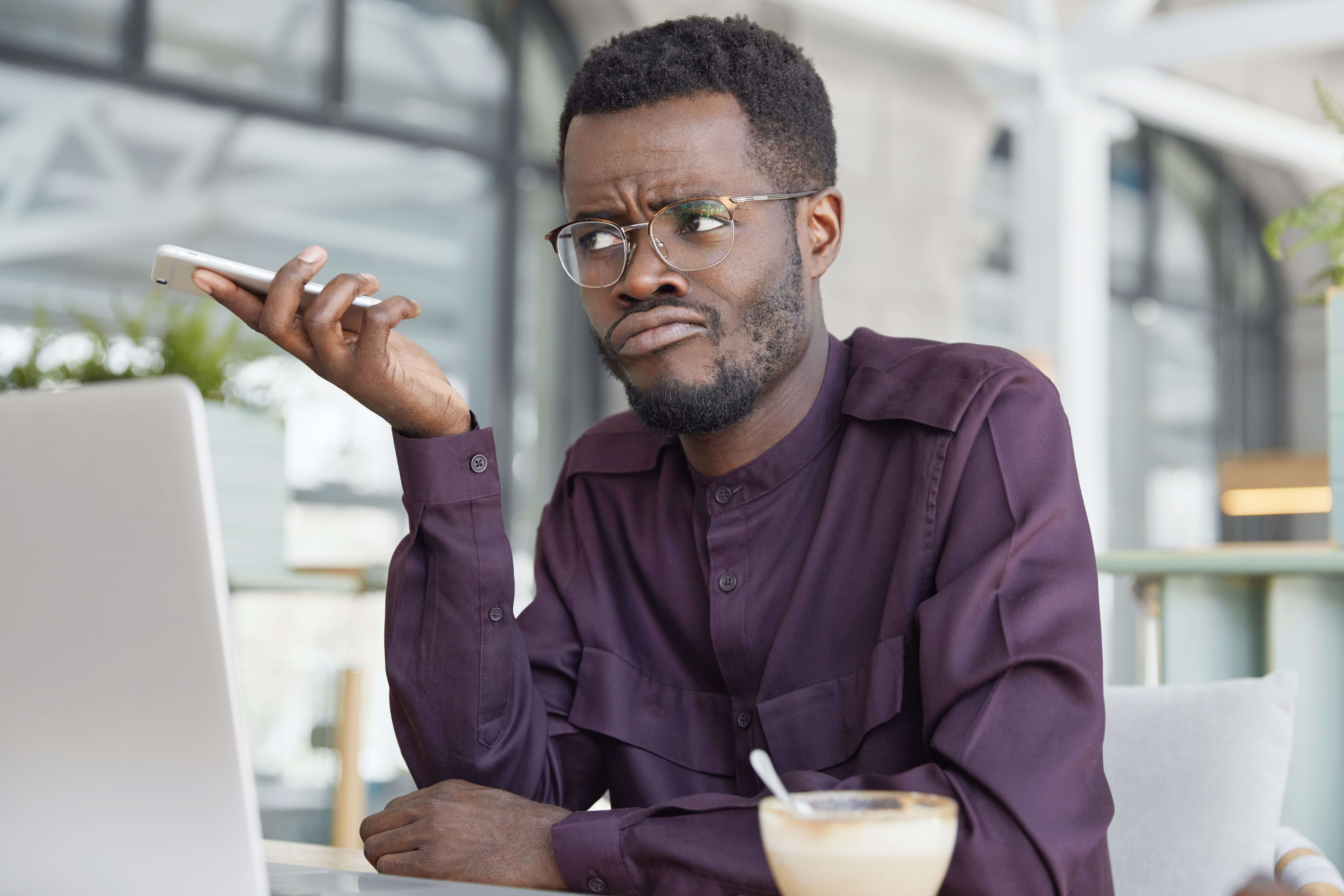 Man with phone, unhappy about slow speed to lead