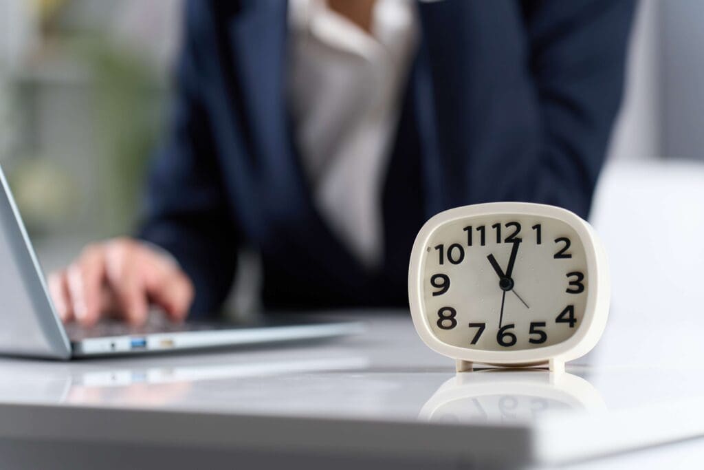 Clock with a woman working in the background