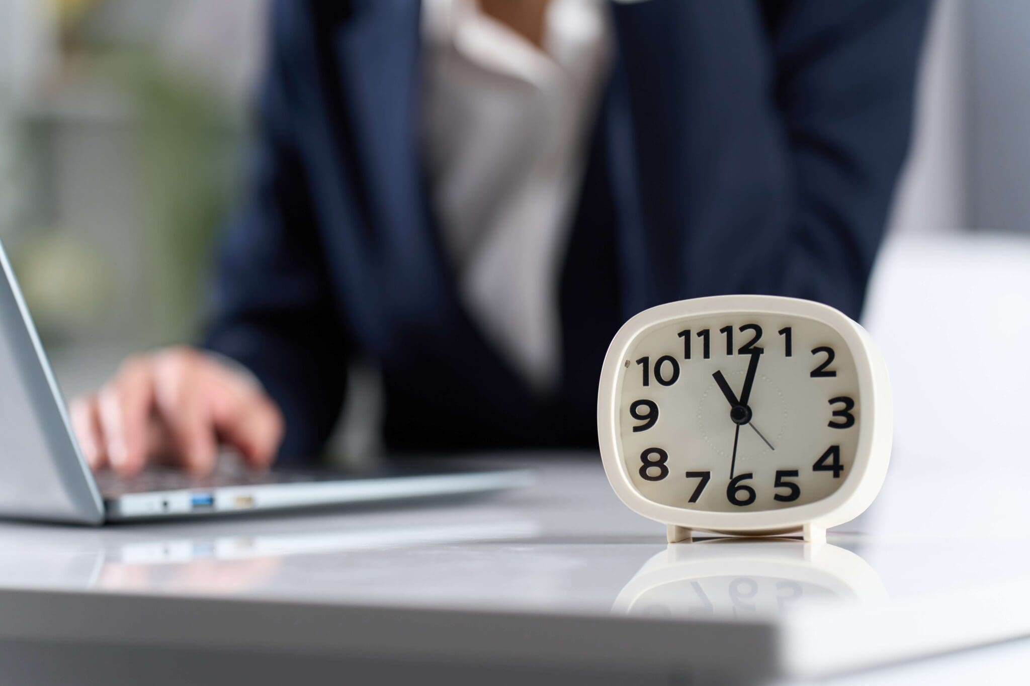Clock with a woman working in the background