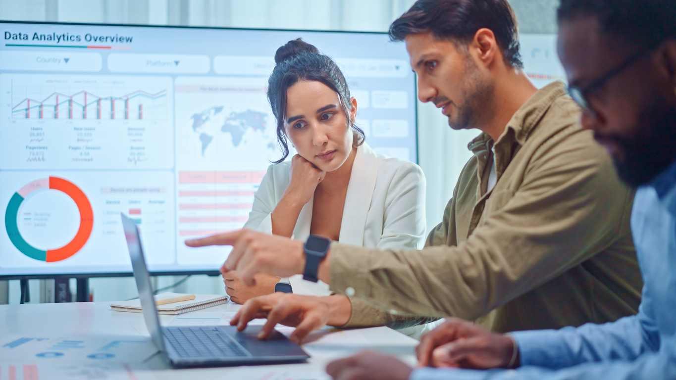 A group of employees analyzes data collected through AI customer service tools.
