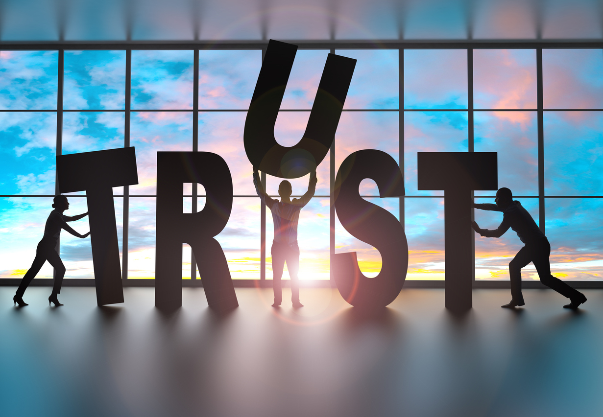Human-sized letters spell out trust, showing a benefit of AI intent-based tools.