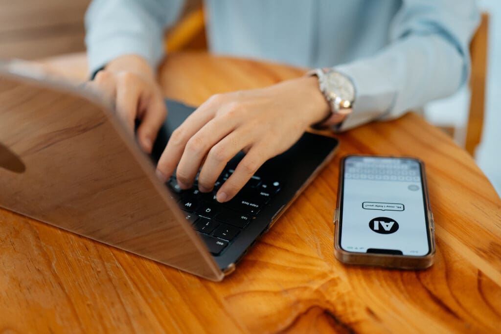 Person receives a text message generated from an AI sales engagement strategy while working on her laptop.