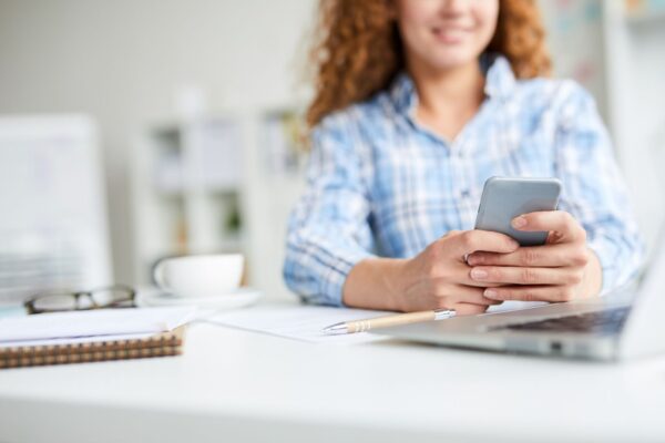 Zoomed out view of a woman on a smartphone