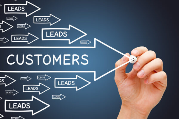 Chalkboard drawing of leads vs. customers shows the importance of conversion.