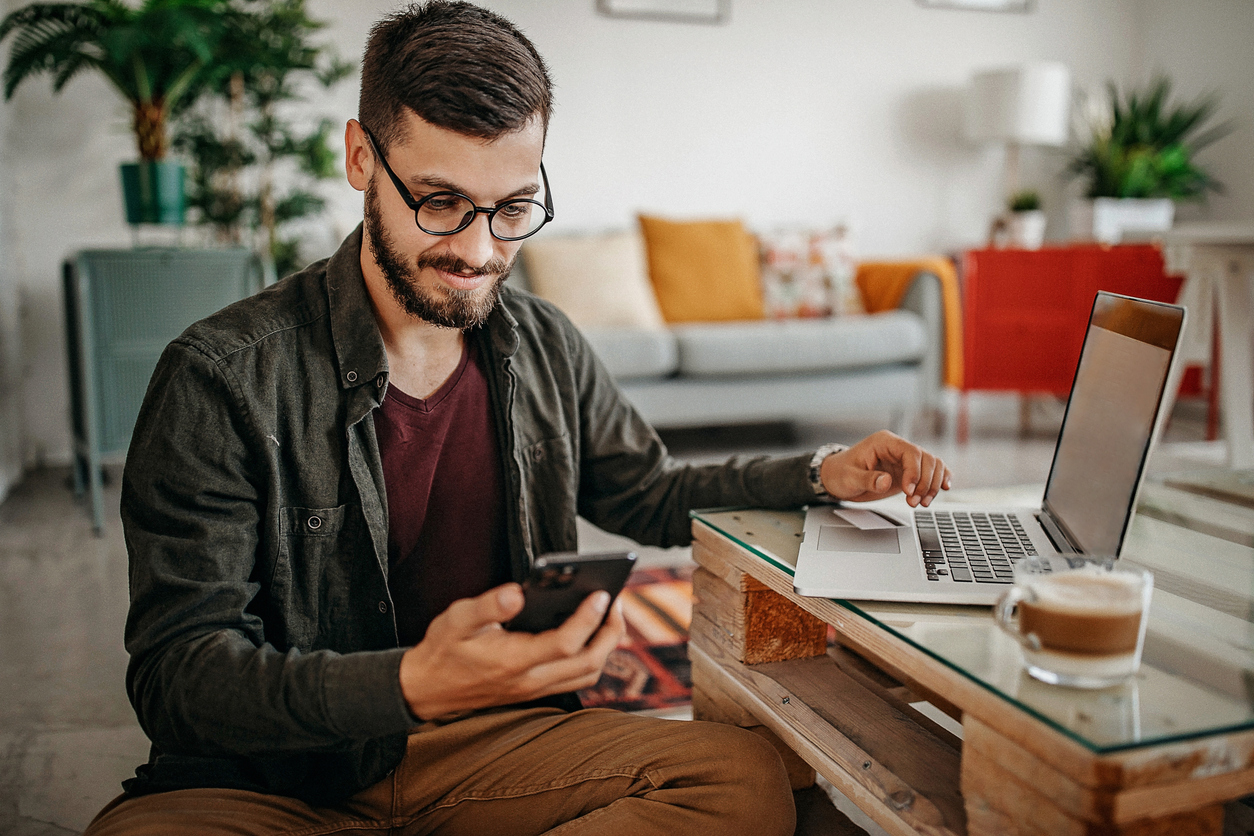 Man reads text messages sent from an AI-powered chatbot, used for lead qualification instead of a sales development representative. 
