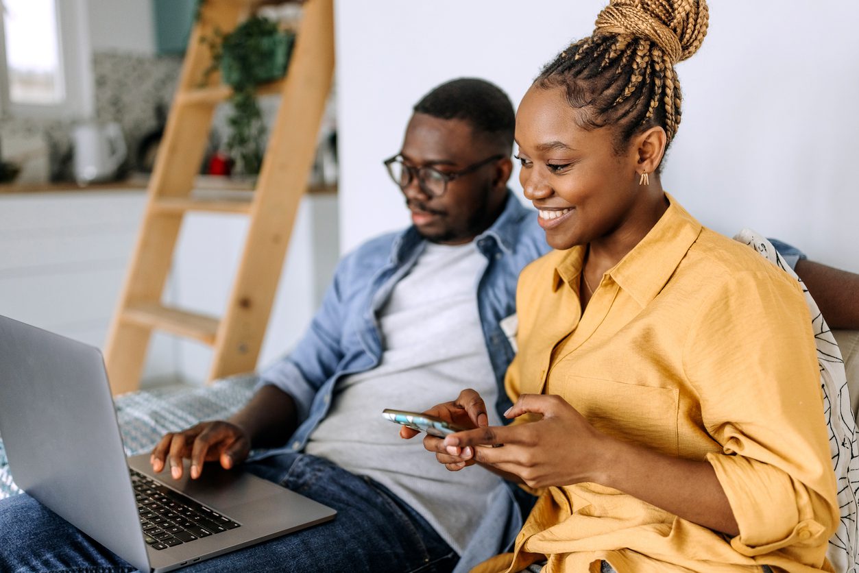 A couple searches online for a home builder, while texting an AI chatbot that gathers data about their interests. 