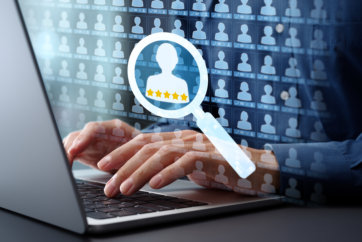 A sales manager is on his laptop reviewing lead scoring parameters as part of a strategy to qualify leads faster. 