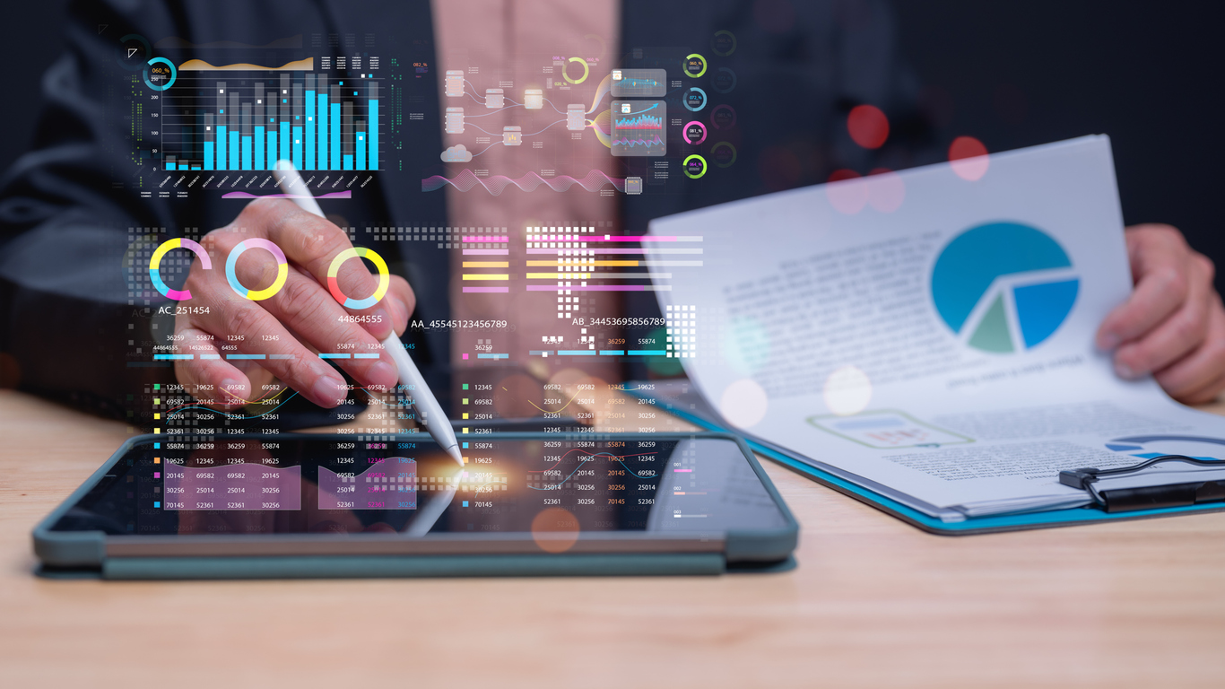 A real estate agent reviews data on a tablet gathered by AI tools to plan and make data-based decisions. 