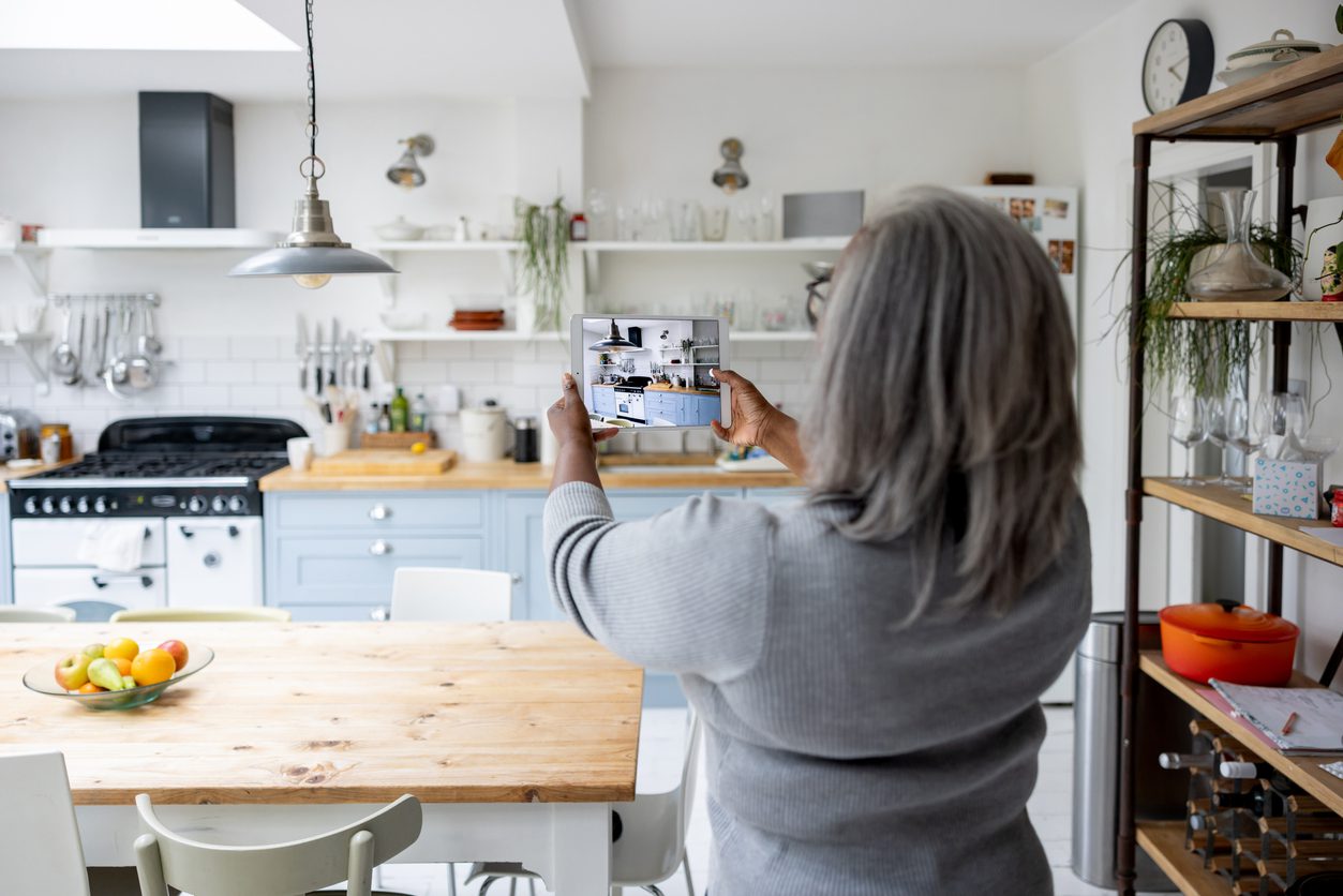 A videographer records a virtual home tour for a real estate company. 