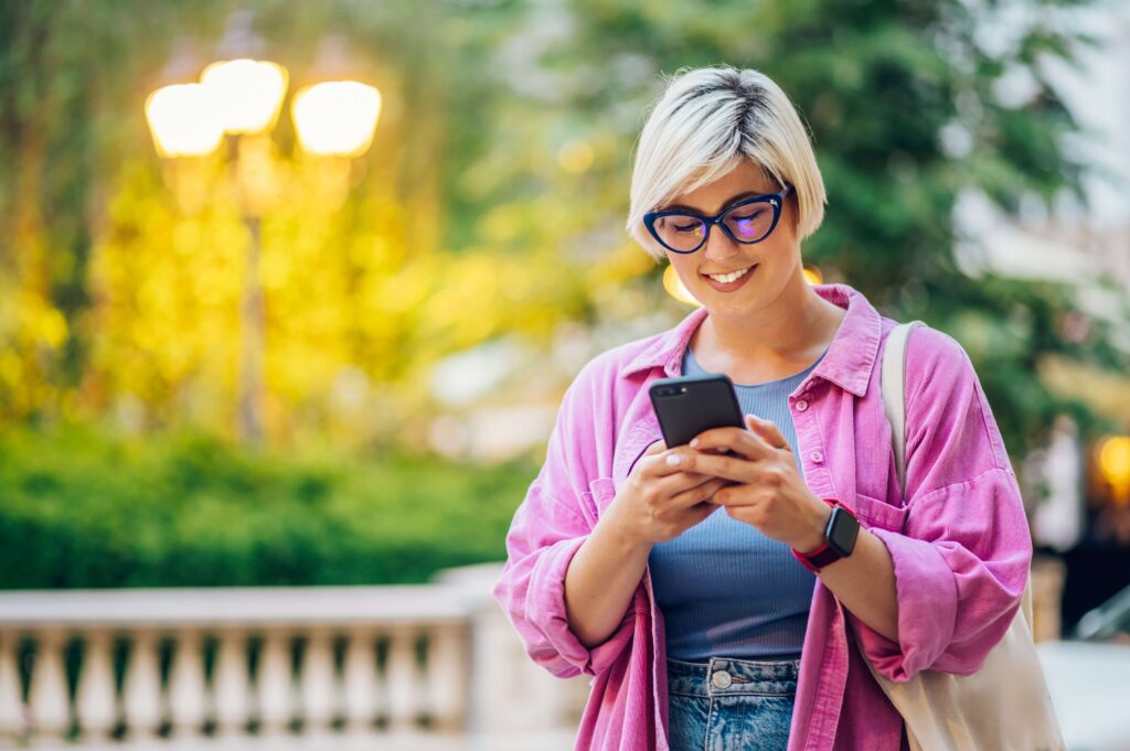 Woman texting with a brand that demonstrates SMS compliance