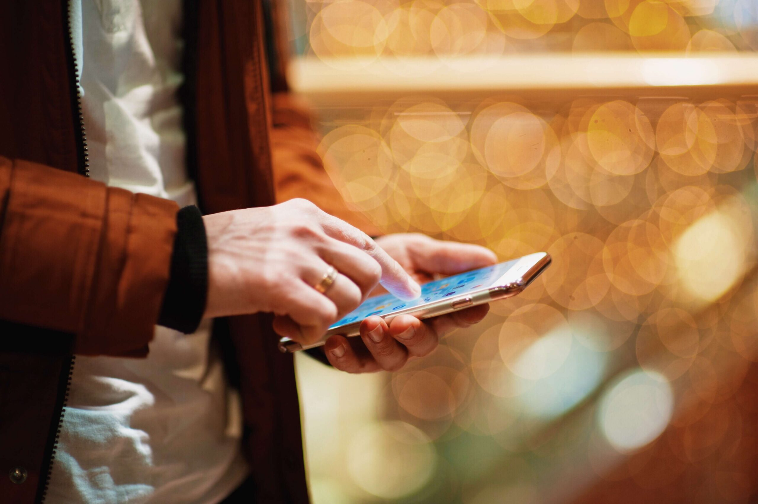 Man uses a smartphone to engage with a brand