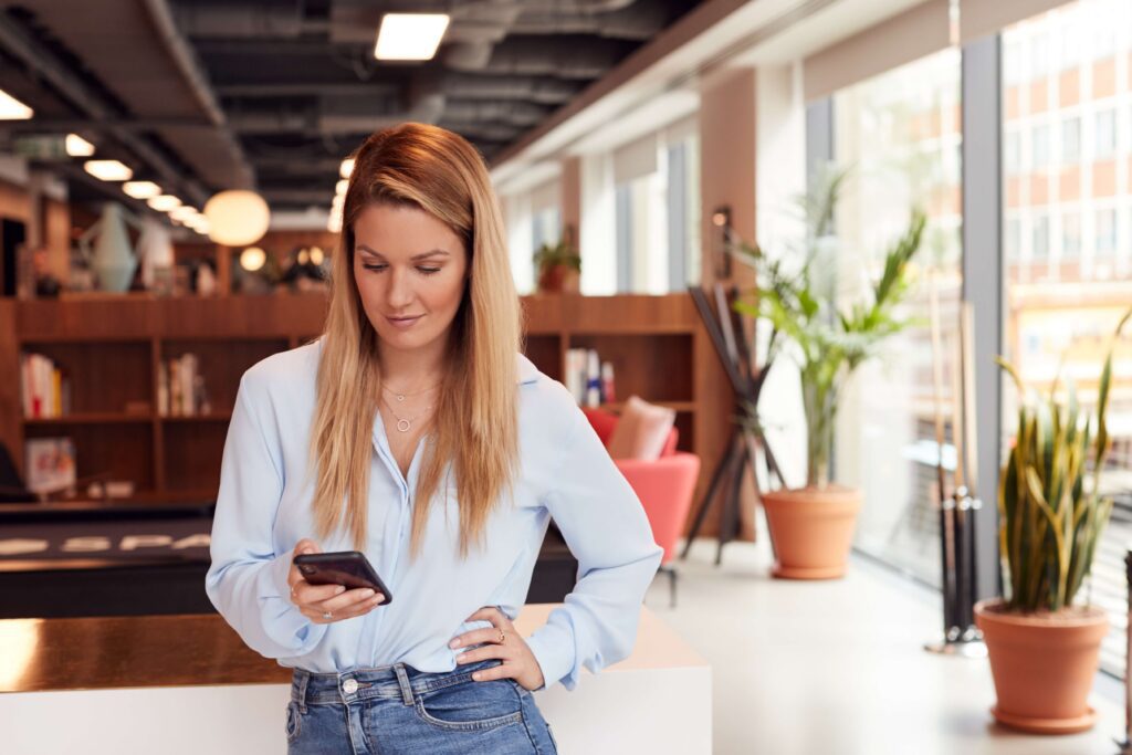 Businesswoman reading a voicemail on her phone