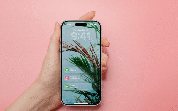 Hand holding a phone with multiple text notifications