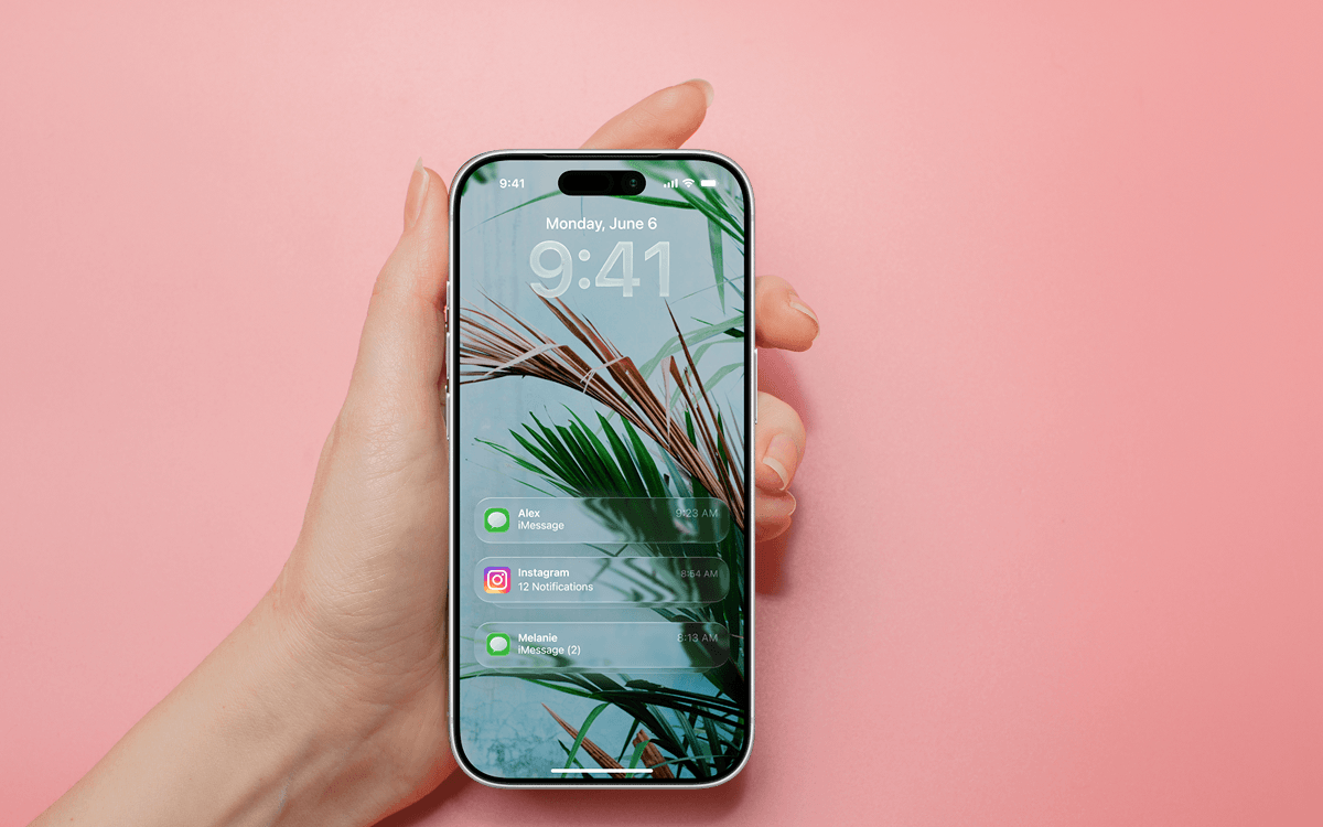 Hand holding a phone with multiple text notifications