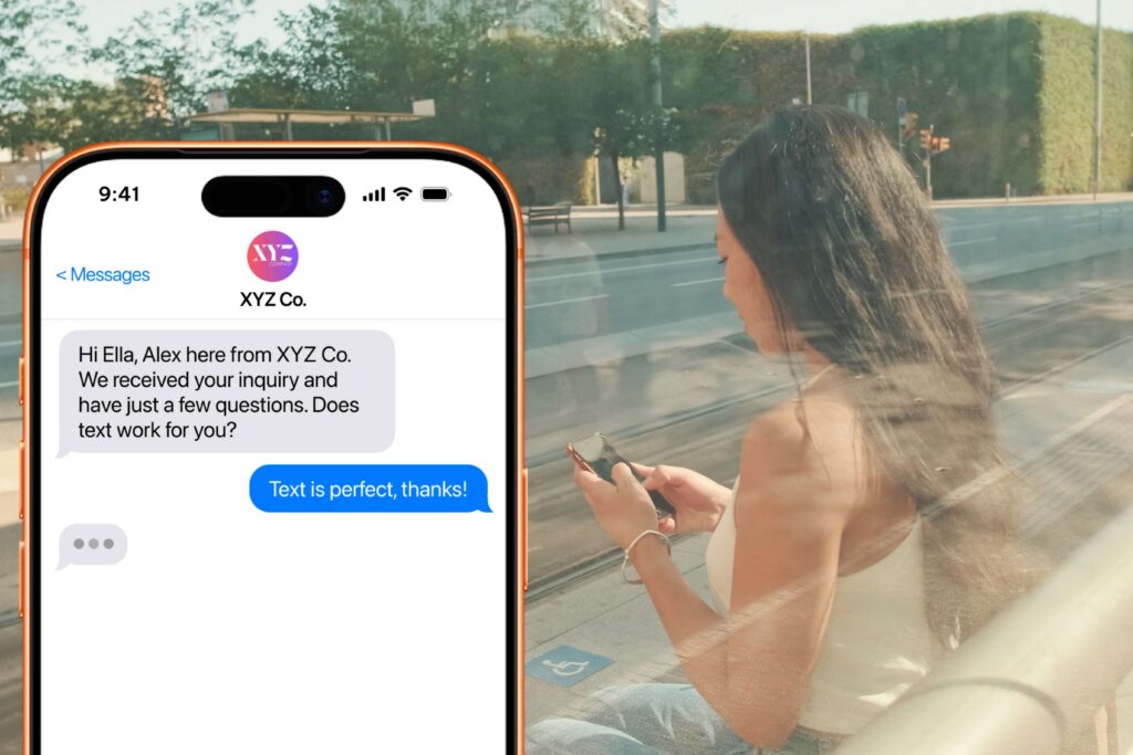 Woman texting at a bus stop