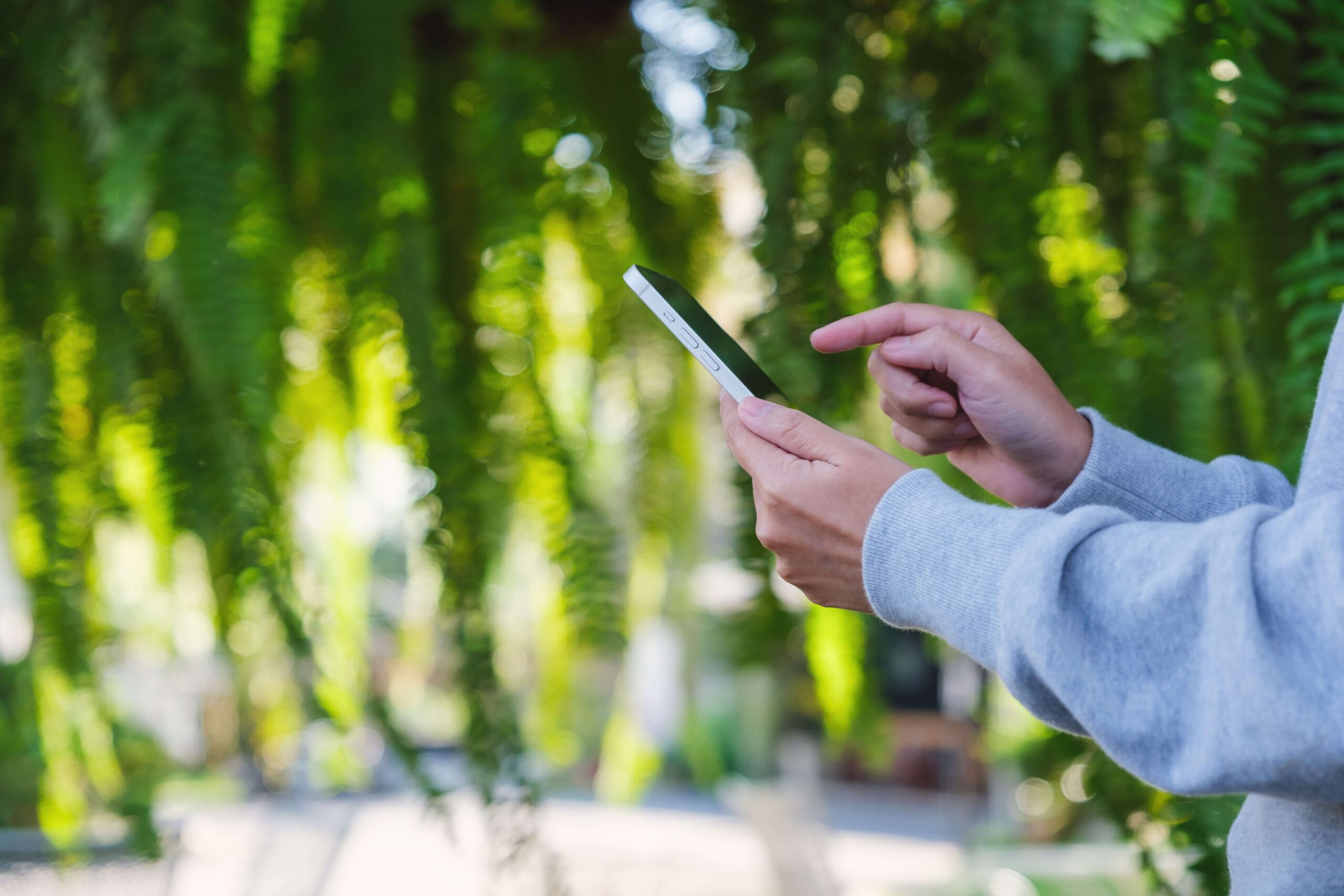 Person using mobile phone outdoors