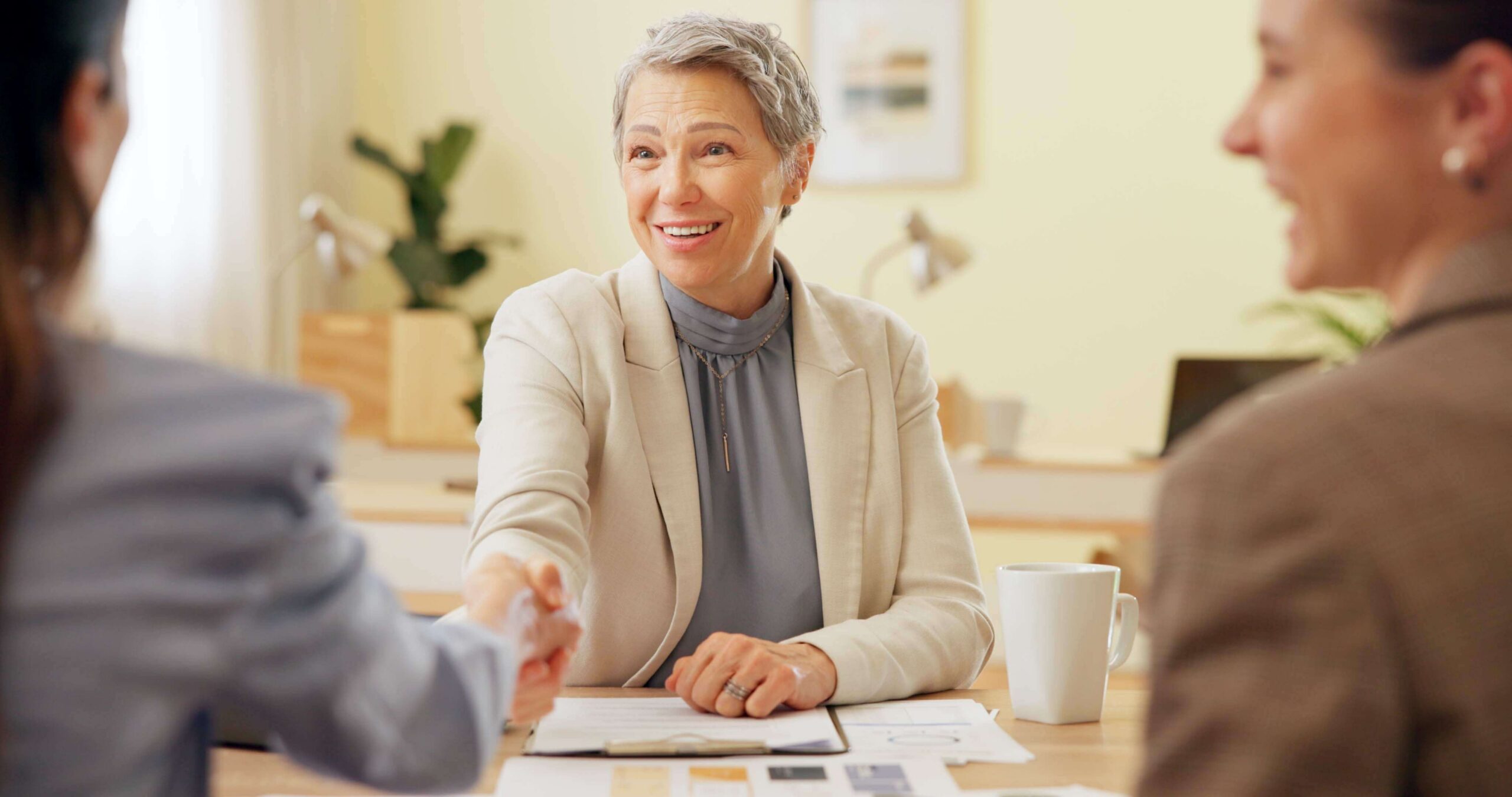 Loan officer shaking hands with a borrower who booked an appointment with AI
