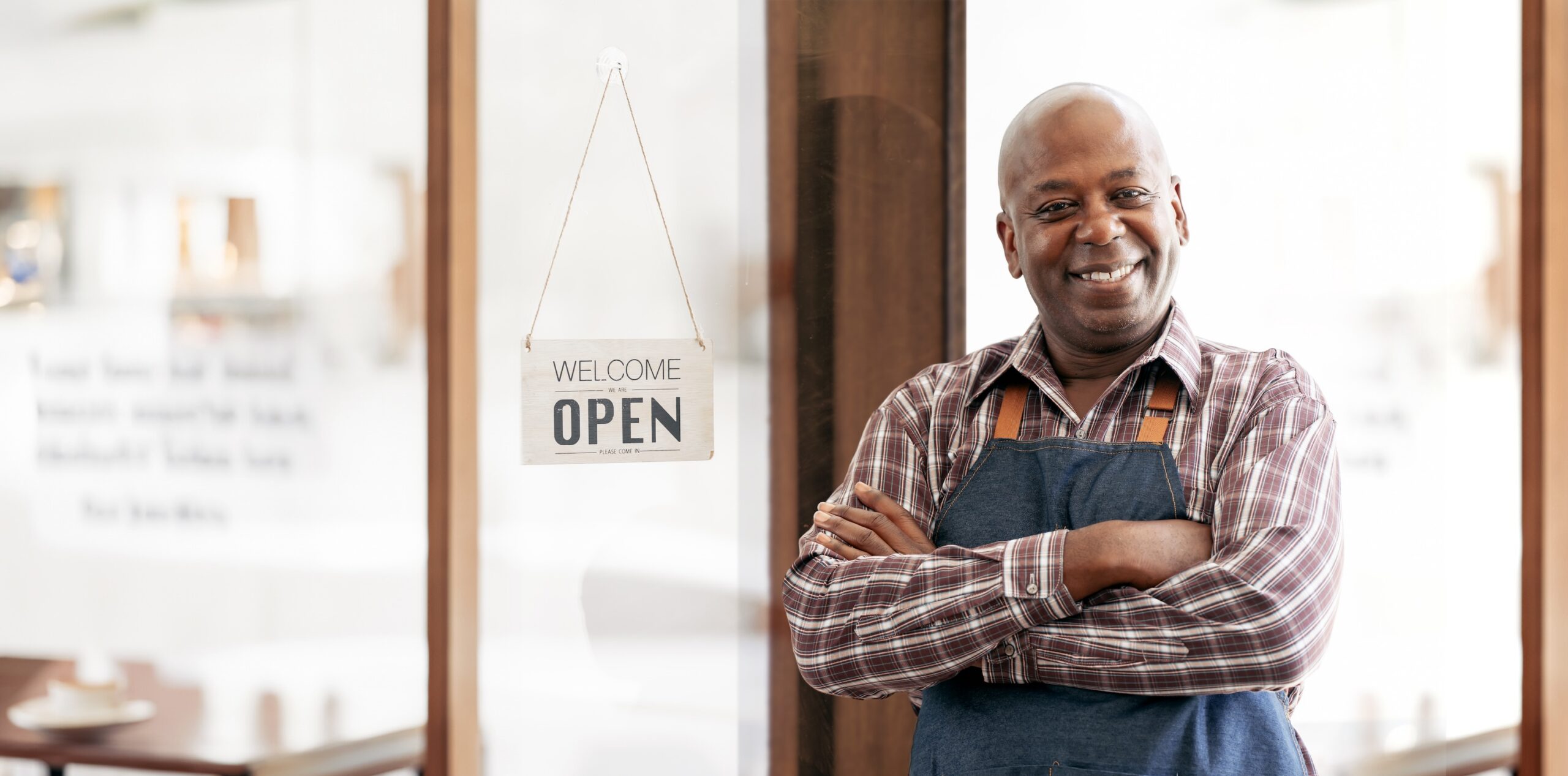 Smiling franchise owner at storefront