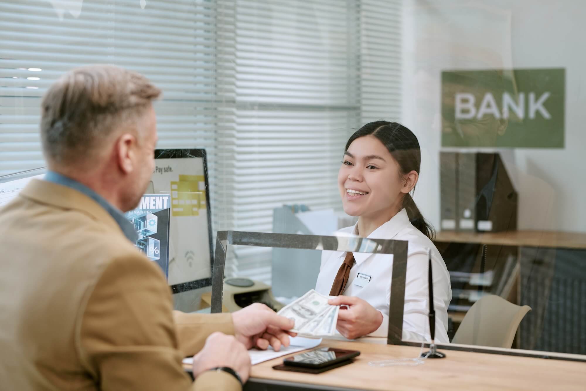 Man at an appointment with his bank after using SMS to schedule